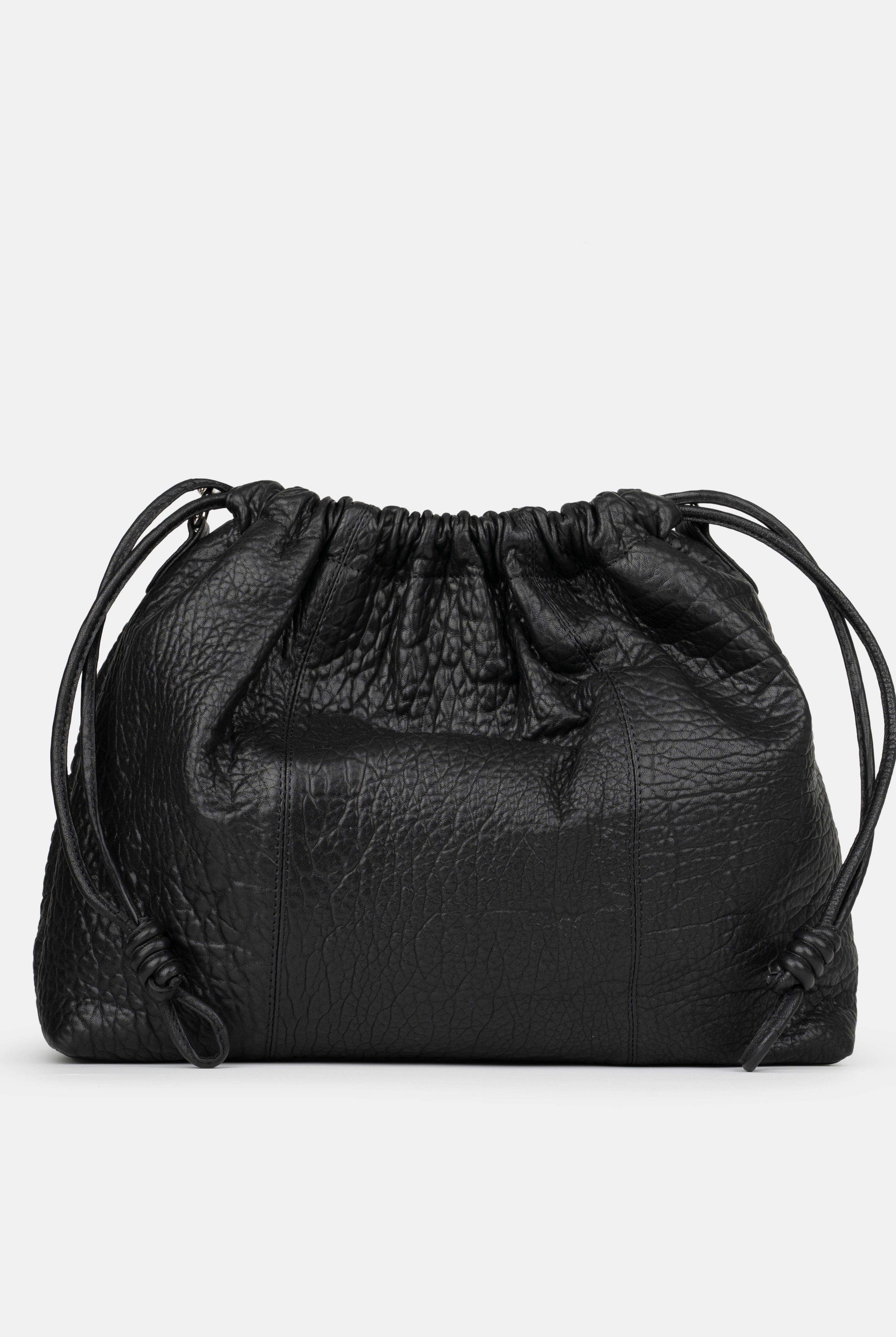 Black leather drawstring bag on a light gray background - back photo