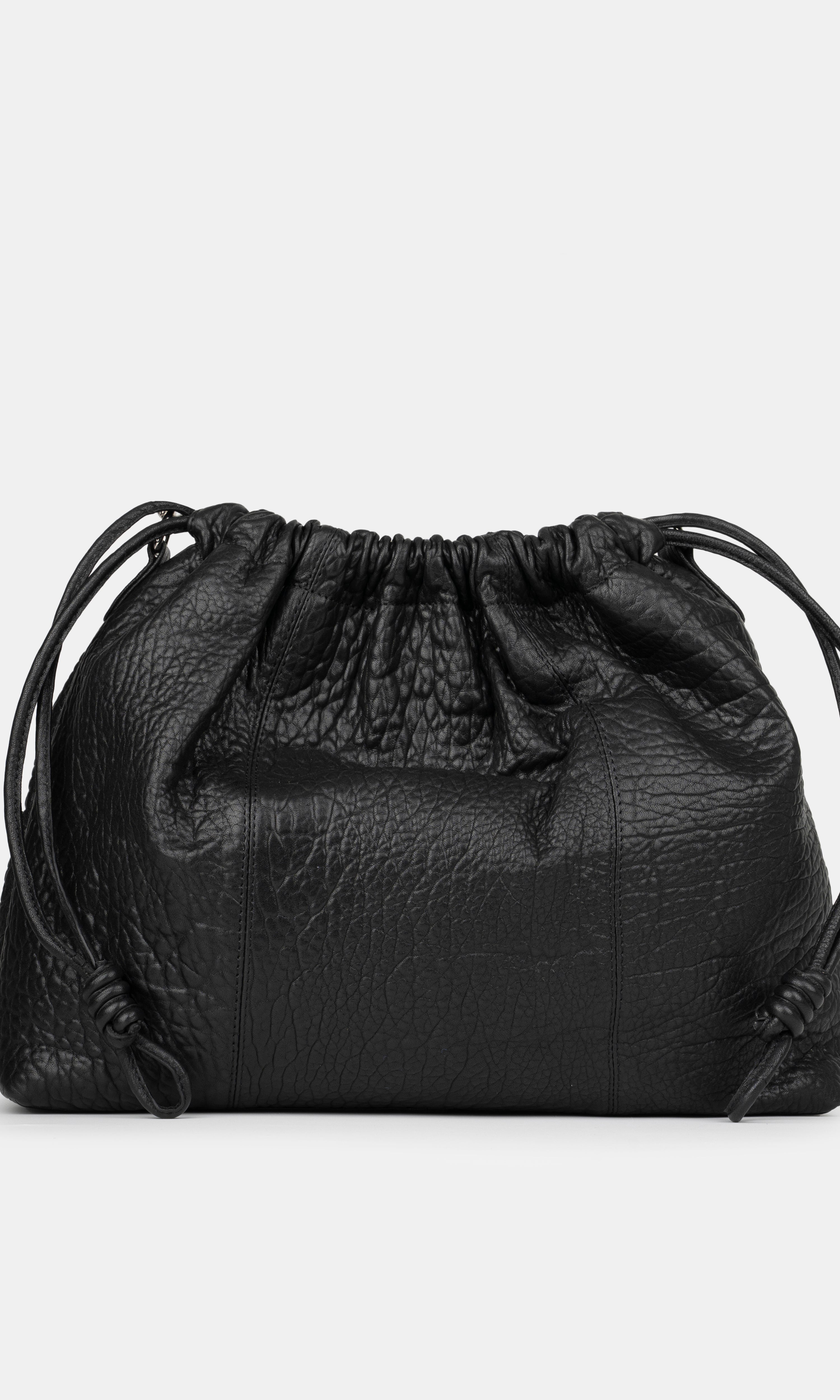 Black leather drawstring bag on a light gray background - back photo