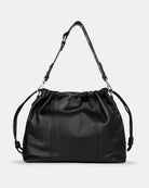 Black leather shoulder and crossbody bag  with drawstring on a light gray background. Front Photo of Elliot Black Neuville