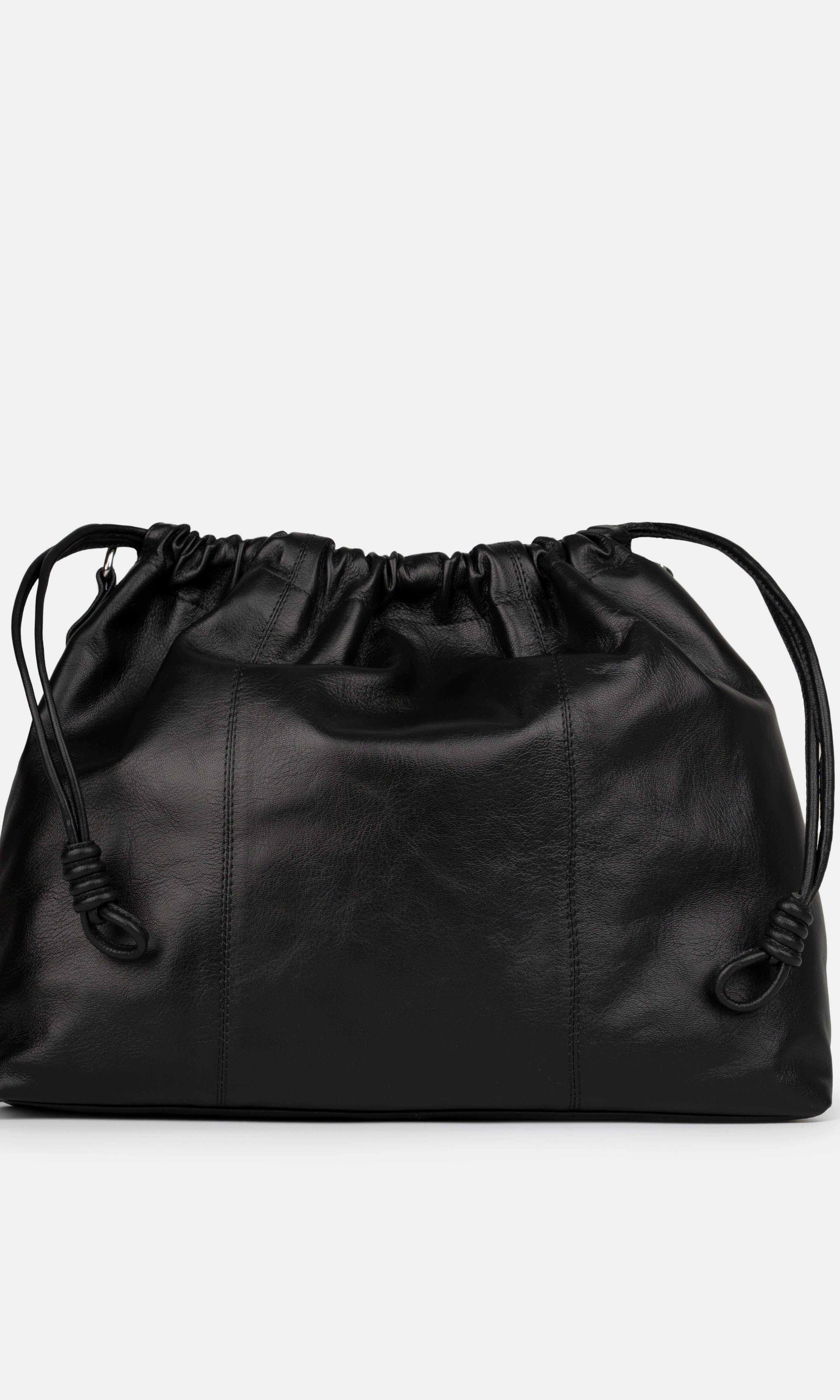 Black leather shoulder and crossbody bag  with drawstring on a light gray background. Back Photo of Elliot Black Neuville