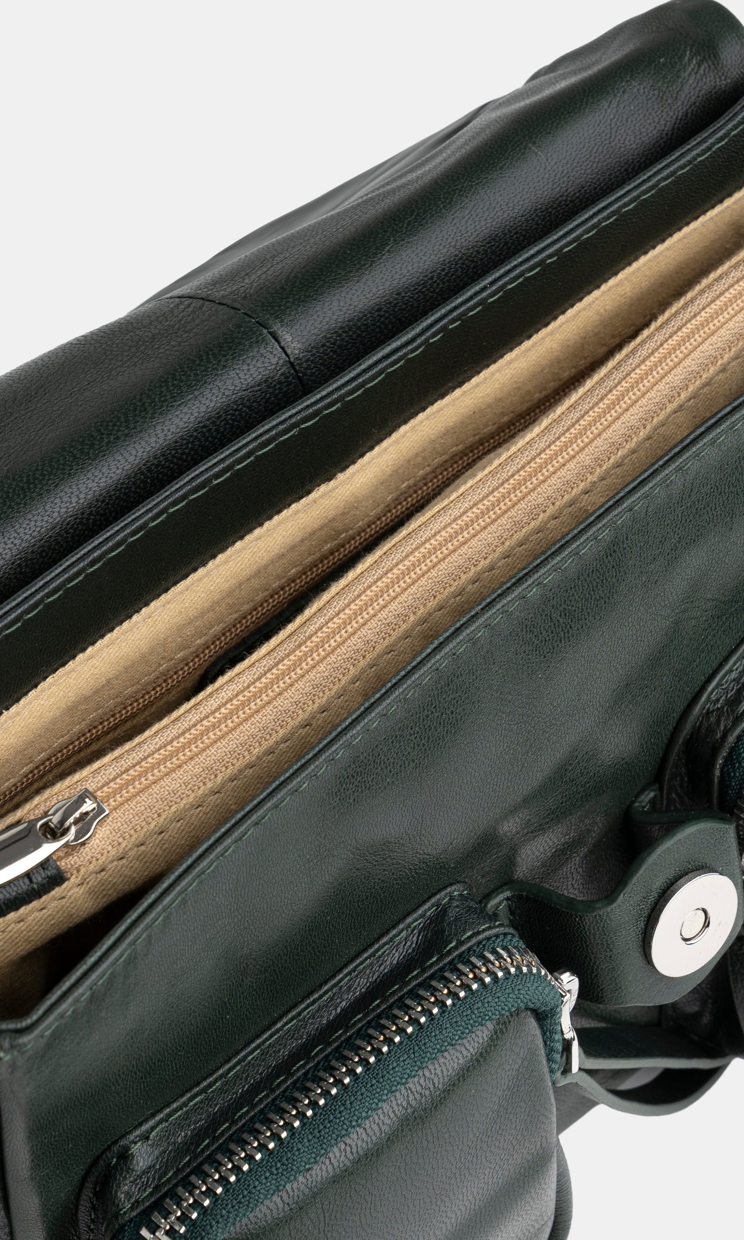 Green leather bag with zippers on a white background