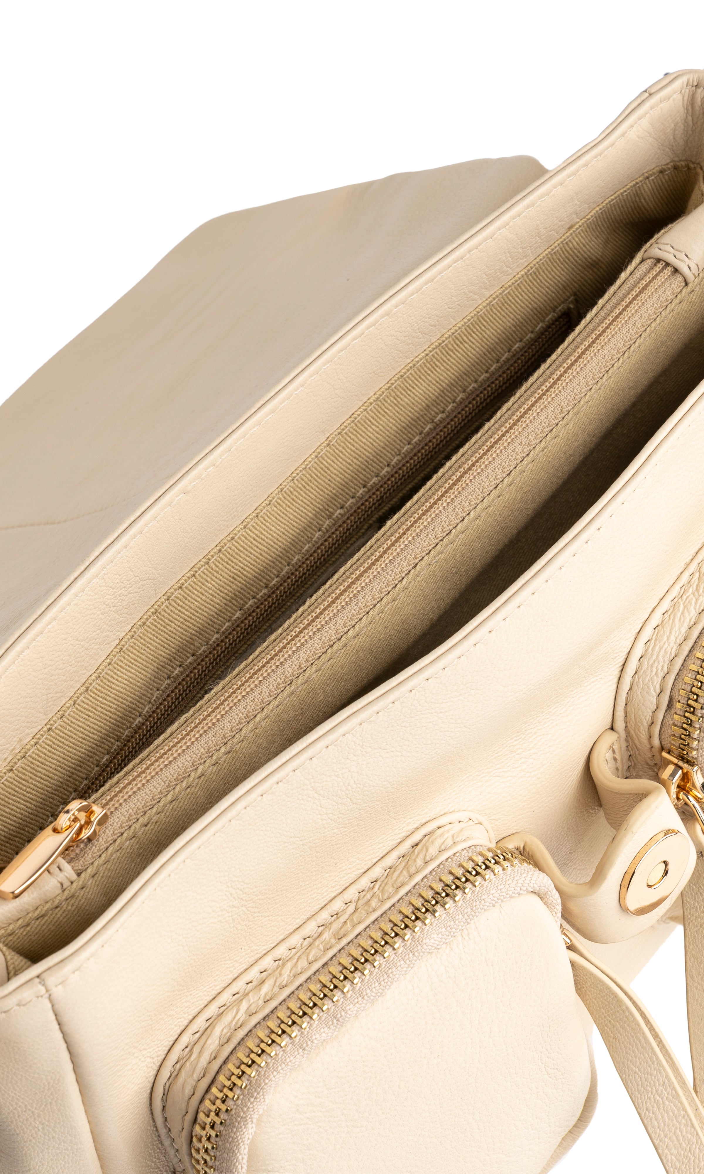 Close-up of a beige handbag with gold zippers and hardware.