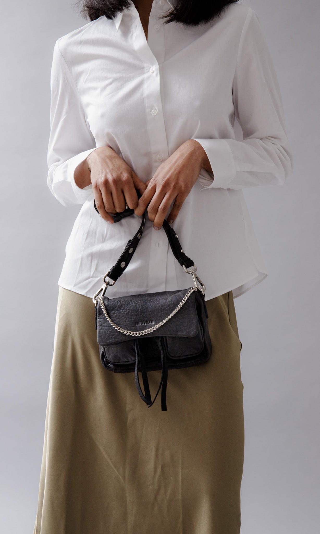 Max Mini Bubble black leather bag in hands of model