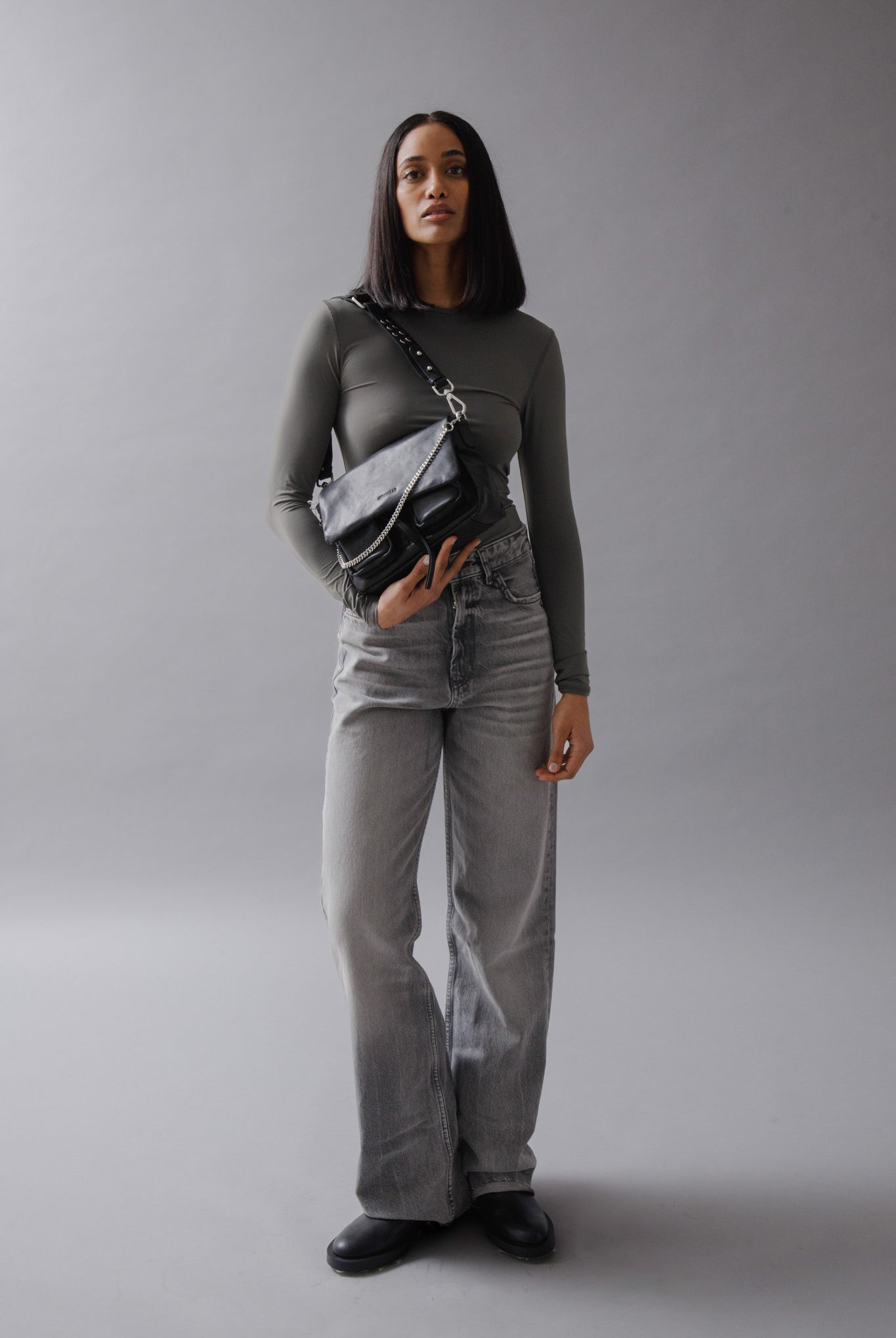 Maxke Black Leather shoulder bag on model in studio.