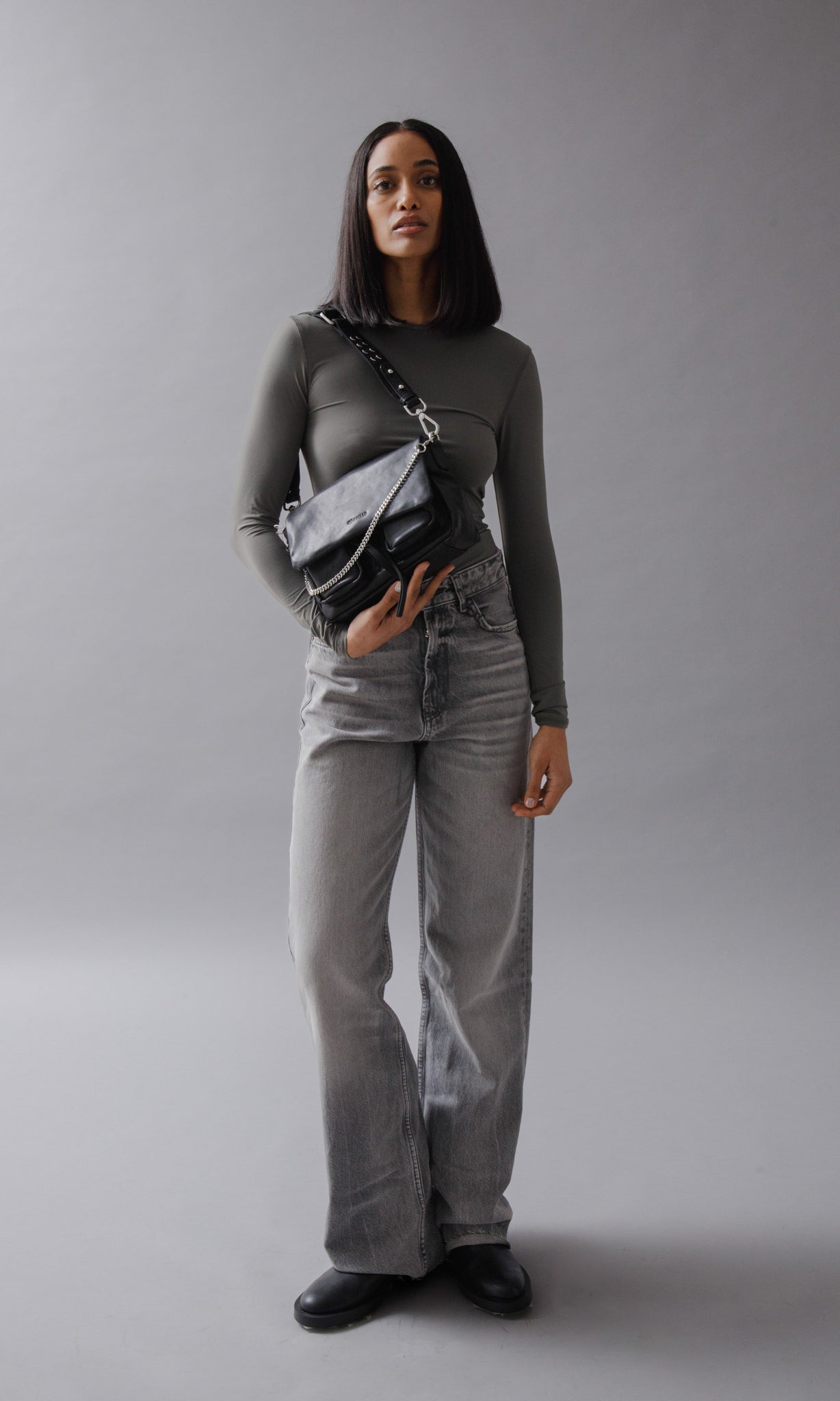 Maxke Black Leather shoulder bag on model in studio.