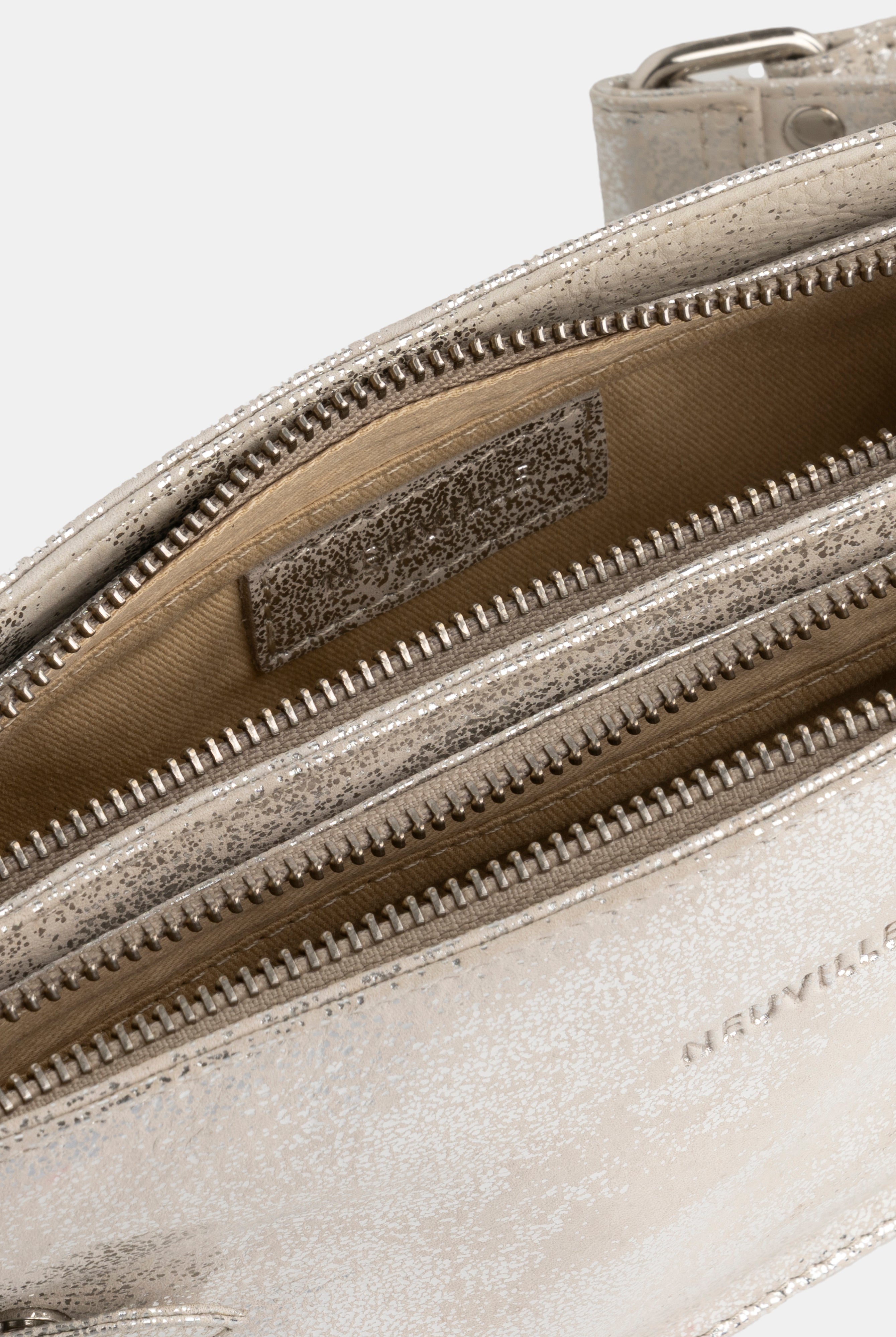 Close-up of a silver handbag with a visible brand logo on a white background