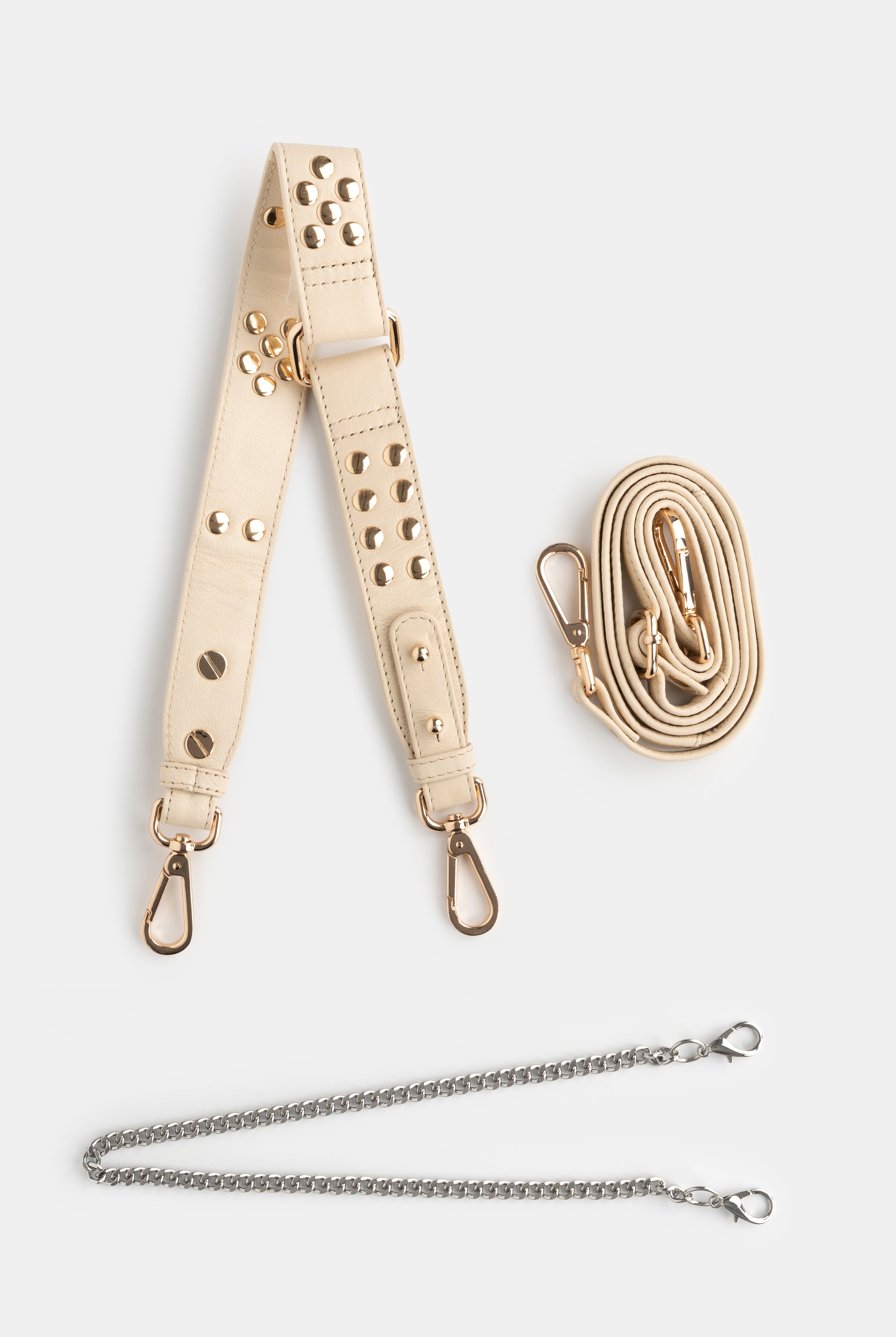 Beige leather strap with metal hardware and a golden chain on a white background