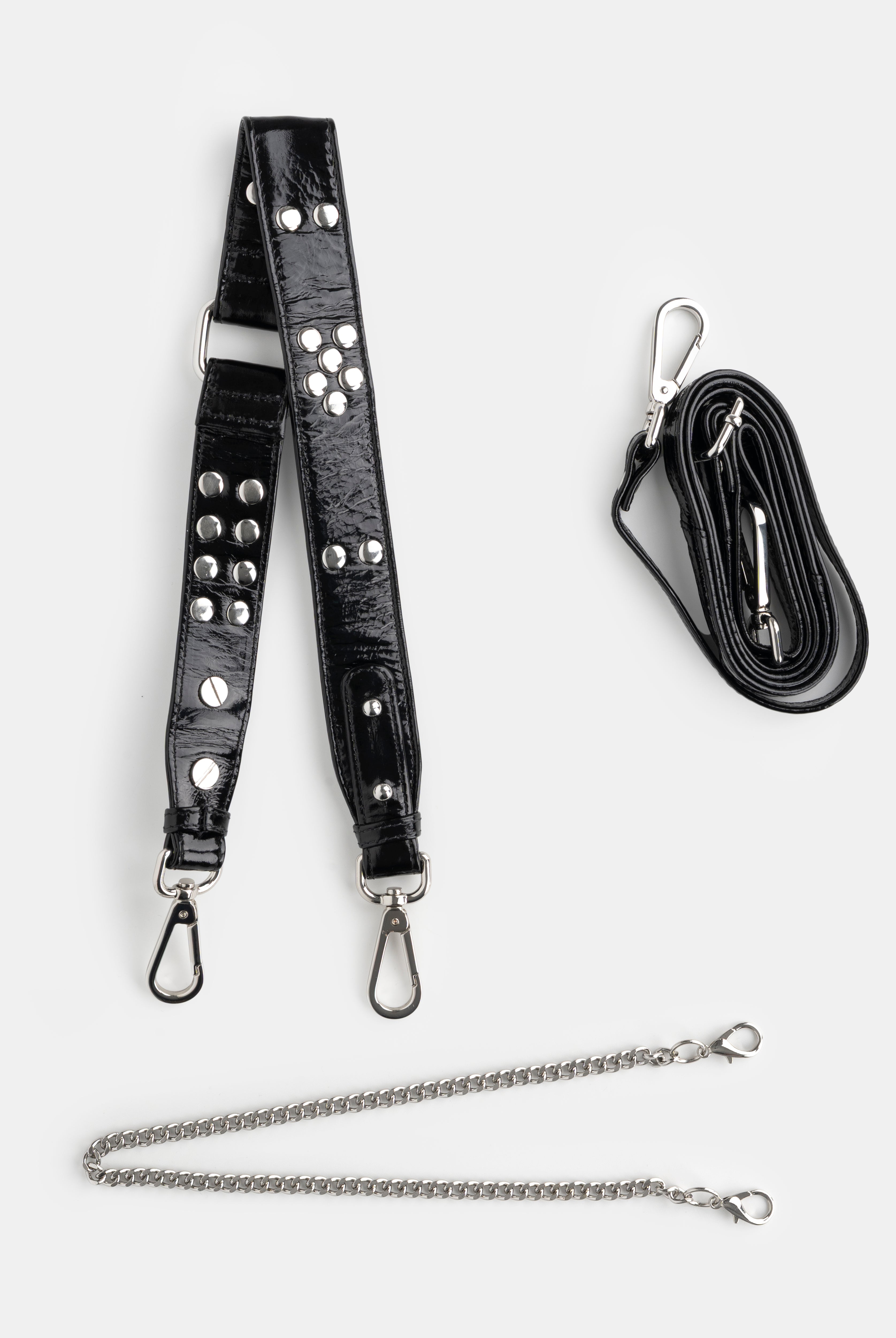 Black leather strap with studs and chain, and a black lanyard on a white background
