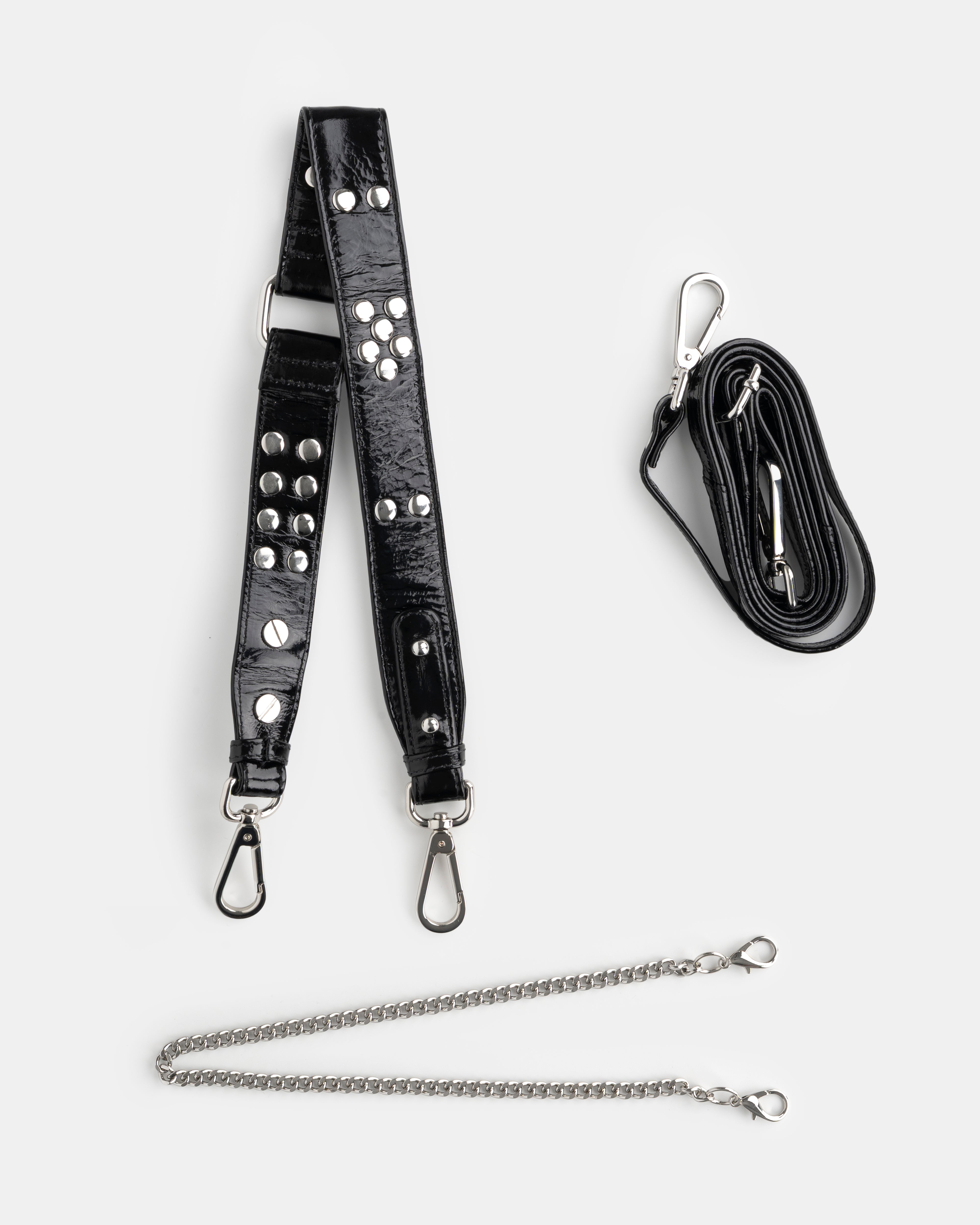 Black leather strap with studs and chain, and a black lanyard on a white background