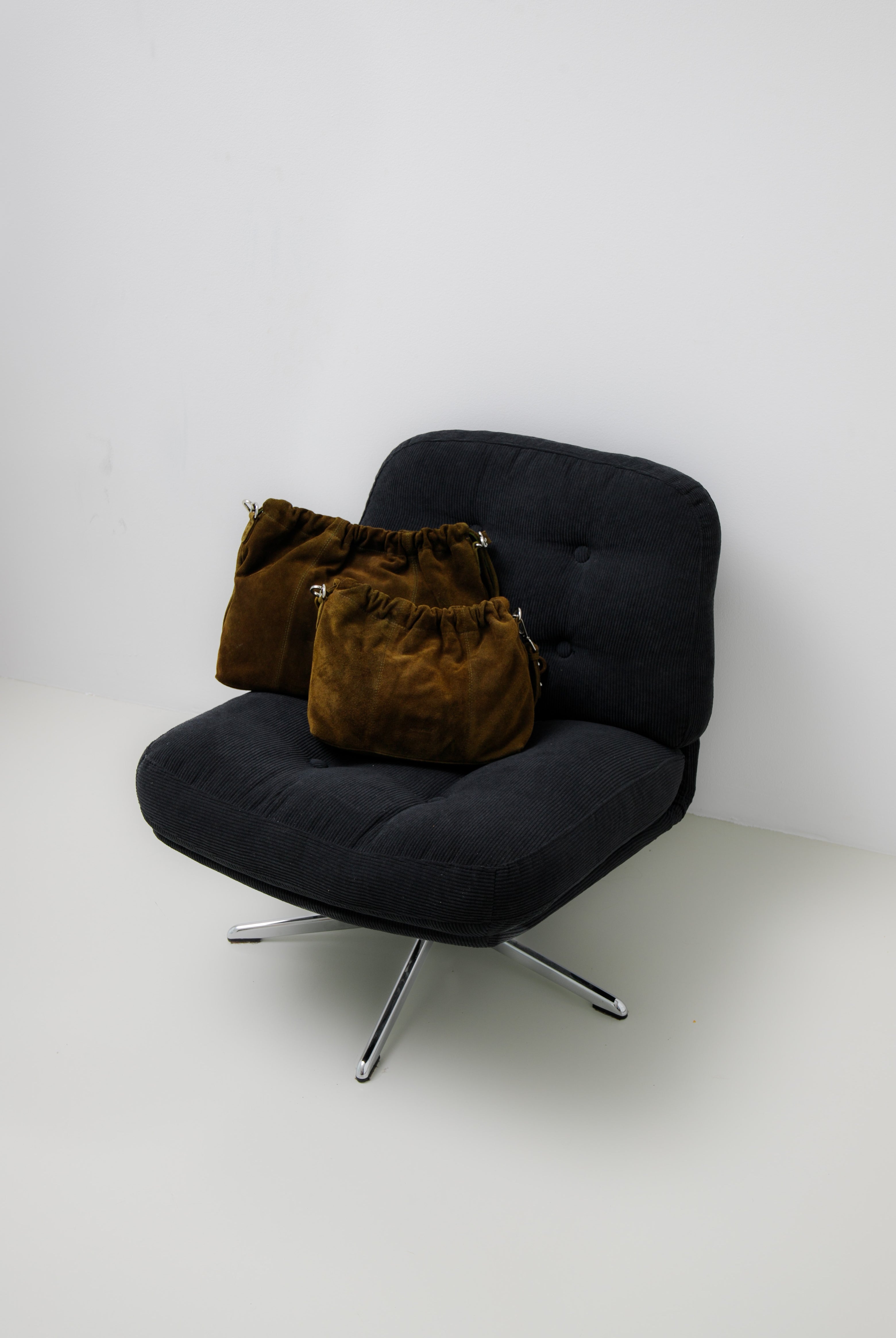 Elliot Suede Khaki on a chair. Neuville bag