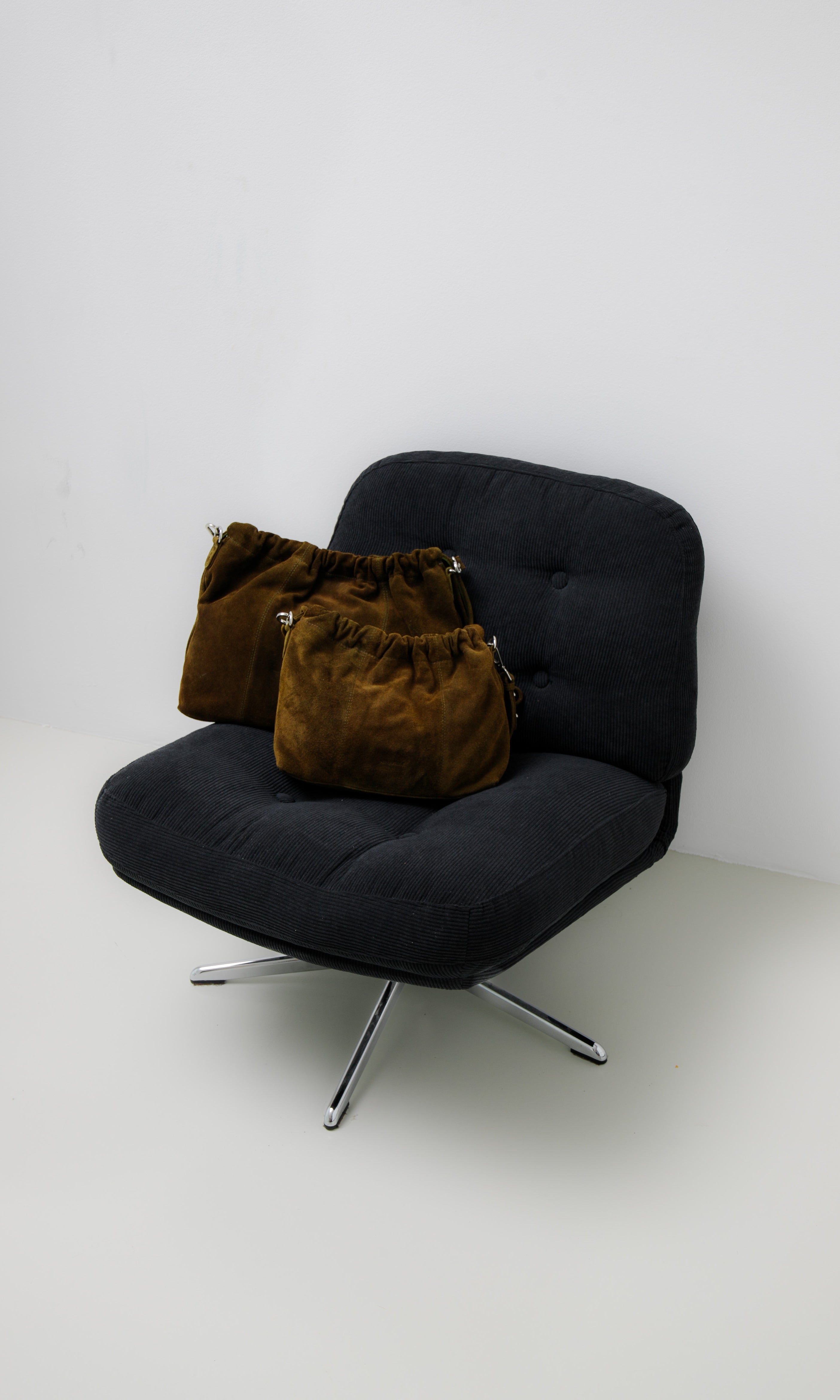 Elliot Suede Khaki on a chair. Neuville bag
