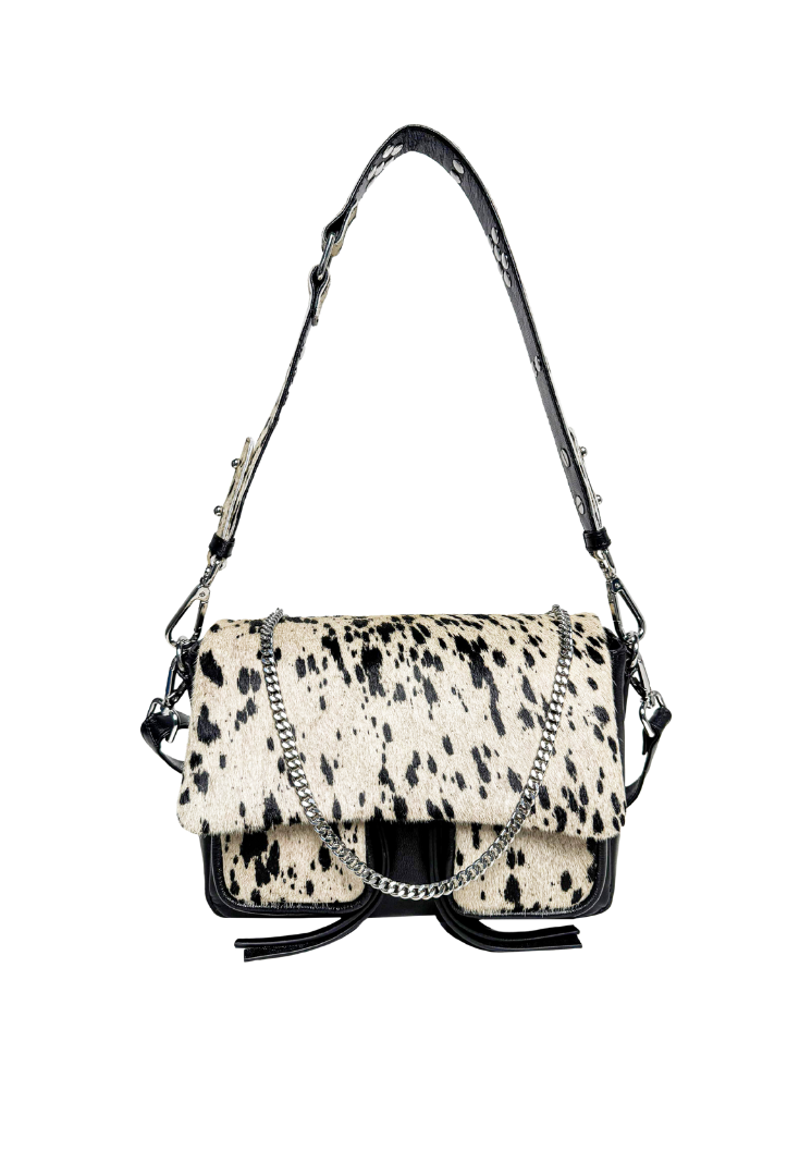A medium-sized black leather handbag with a cowhide pattern, featuring a shoulder strap, a crossbody strap, and a chain detail, displayed against a white background.