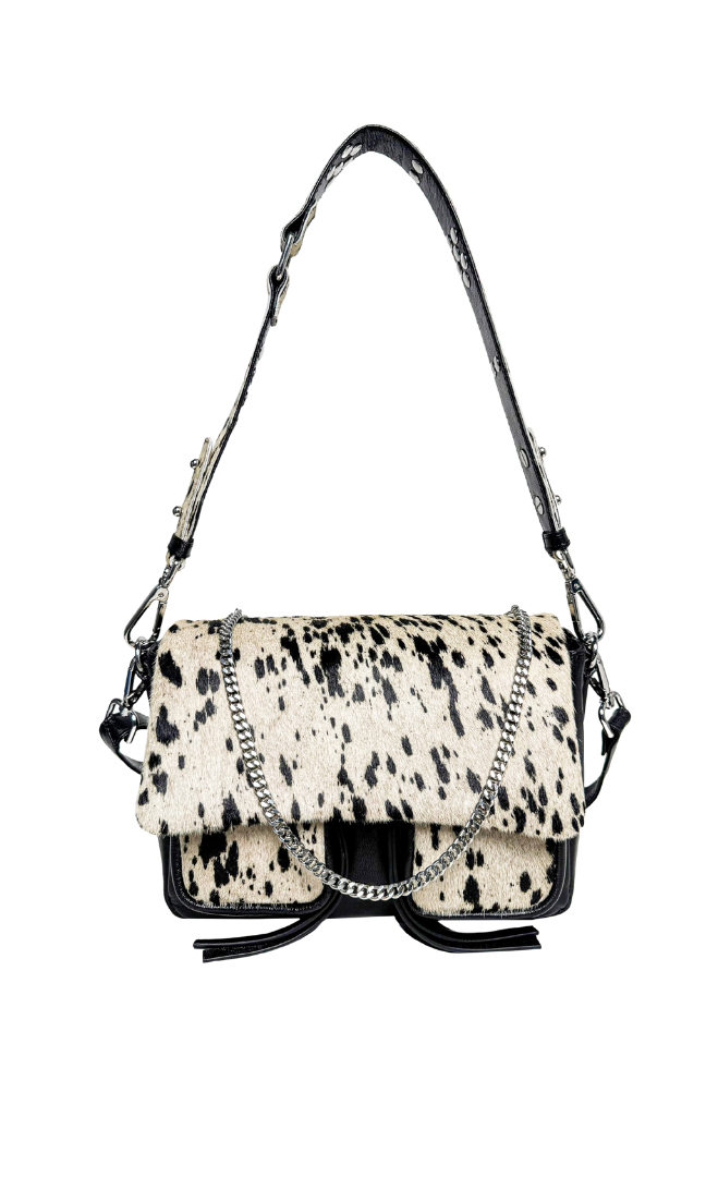 A medium-sized black leather handbag with a cowhide pattern, featuring a shoulder strap, a crossbody strap, and a chain detail, displayed against a white background.