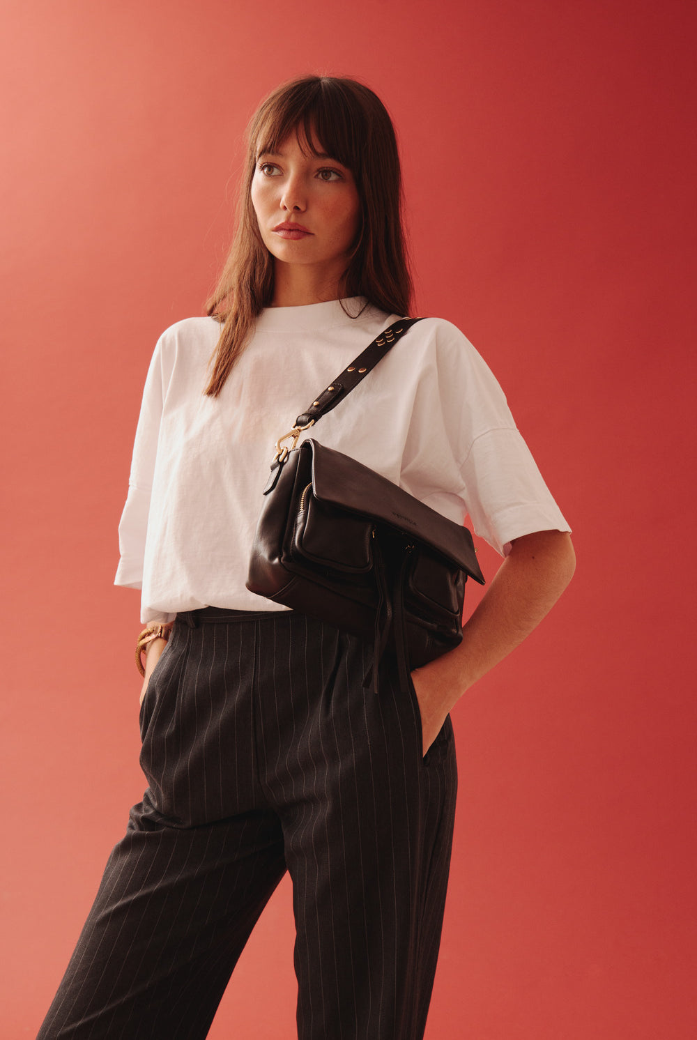 Maxke Black with golden details, leather shoulder bag on model