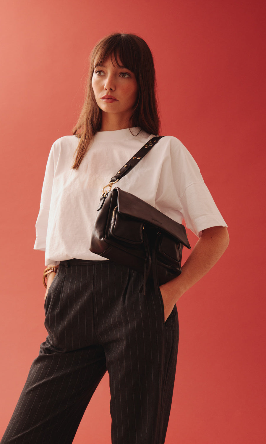 Maxke Black with golden details, leather shoulder bag on model