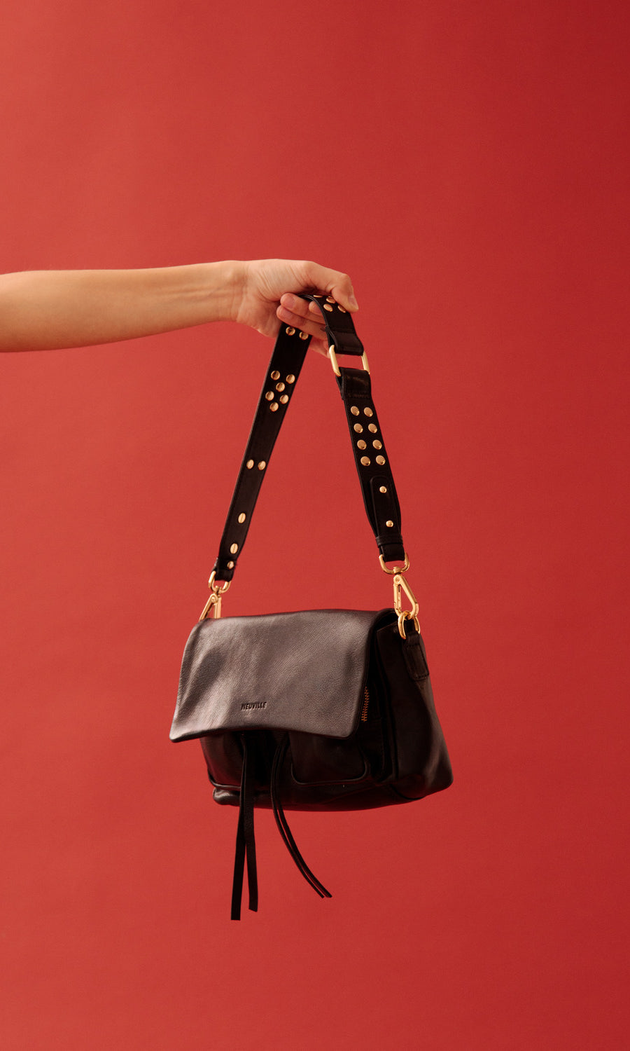 Maxke Black with Golden Details, product shot with red background