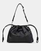 Black drawstring bag with adjustable strap on a light gray background