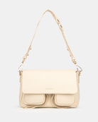 Beige handbag with a strap on a light gray background