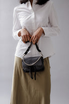 Max Mini Bubble black leather bag in hands of model