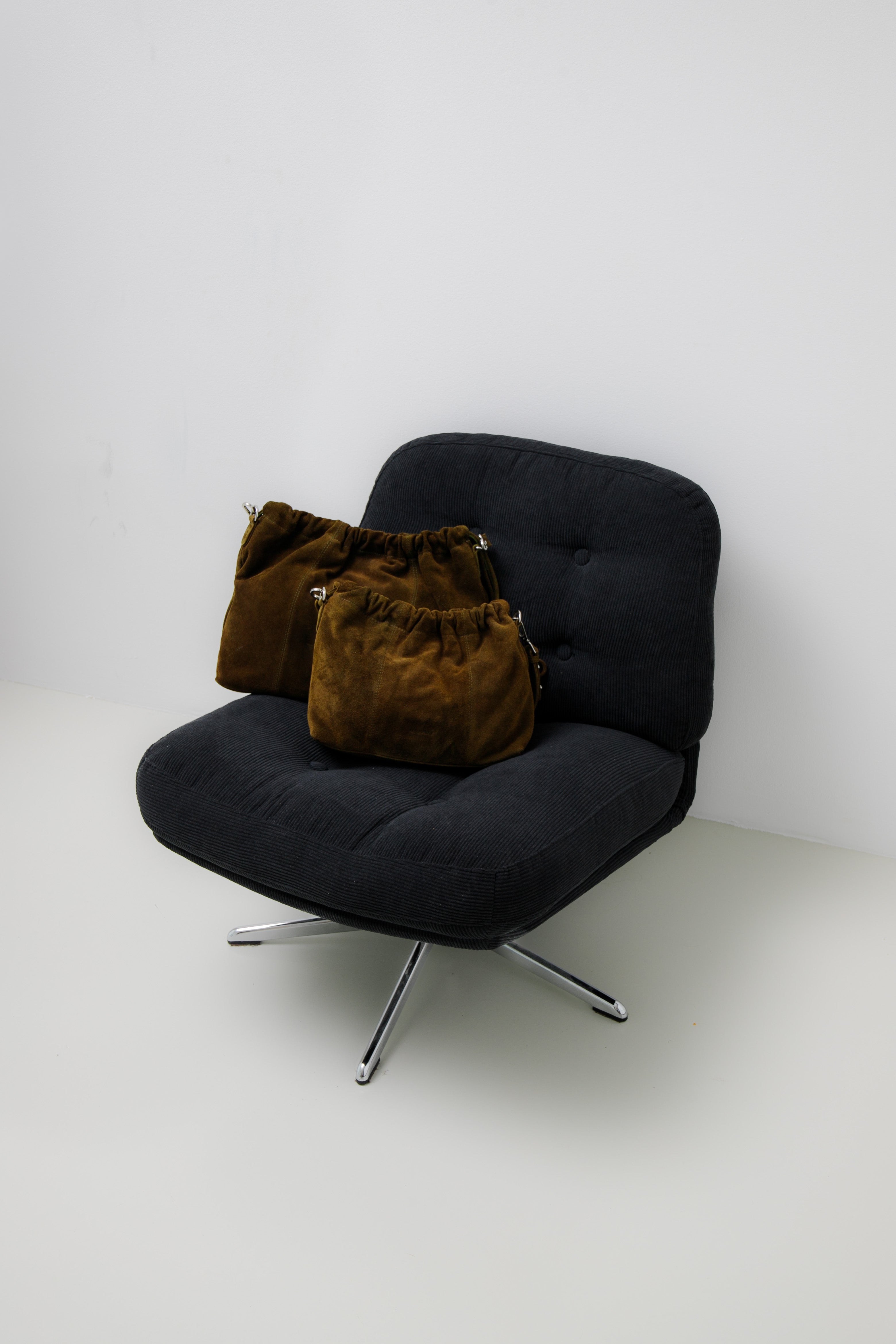 Elliot Suede Khaki on a chair. Neuville bag