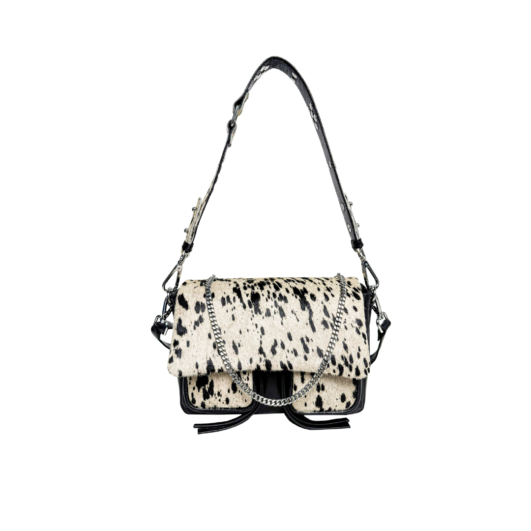 A medium-sized black leather handbag with a cowhide pattern, featuring a shoulder strap, a crossbody strap, and a chain detail, displayed against a white background.